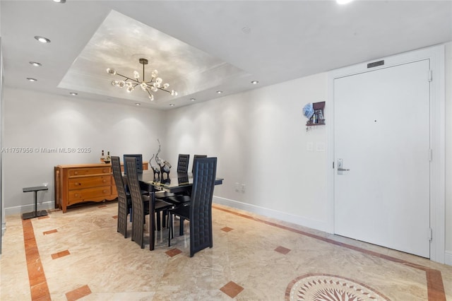 dining area with a notable chandelier, a tray ceiling, recessed lighting, and baseboards