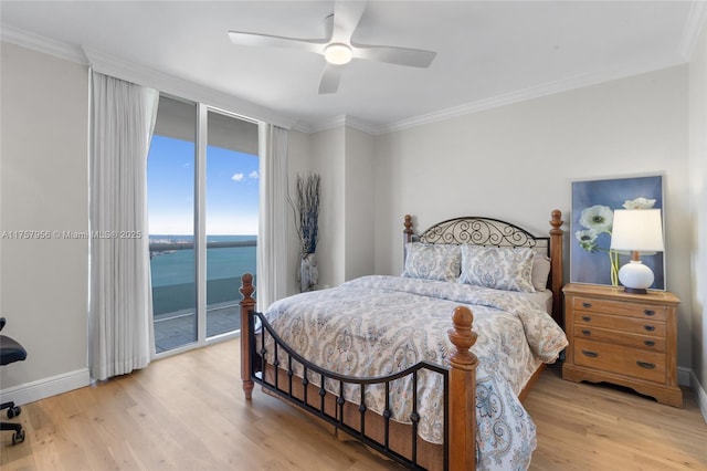 bedroom featuring ornamental molding, a water view, wood finished floors, and access to exterior