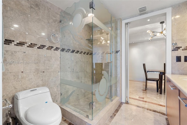 full bath with visible vents, toilet, vanity, a shower stall, and a chandelier