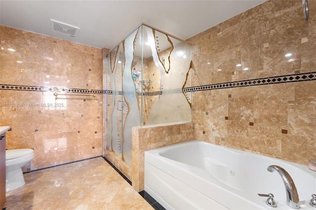 bathroom featuring toilet, visible vents, tile walls, a bath, and a stall shower