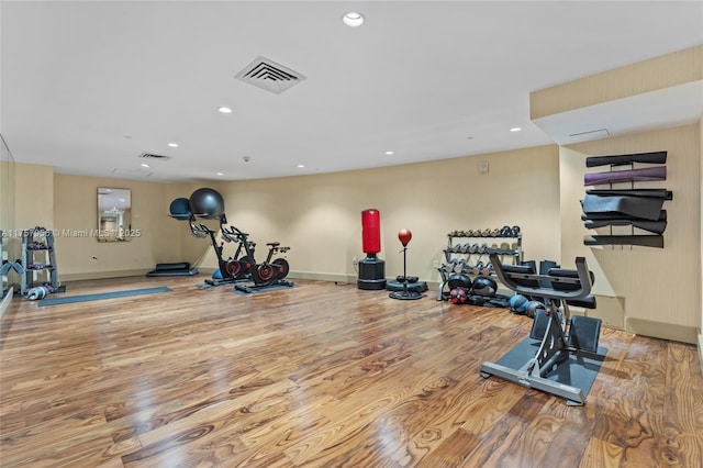 workout area with visible vents and wood finished floors