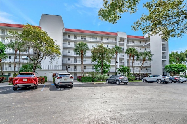 view of building exterior featuring uncovered parking