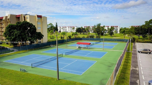 view of tennis court featuring fence