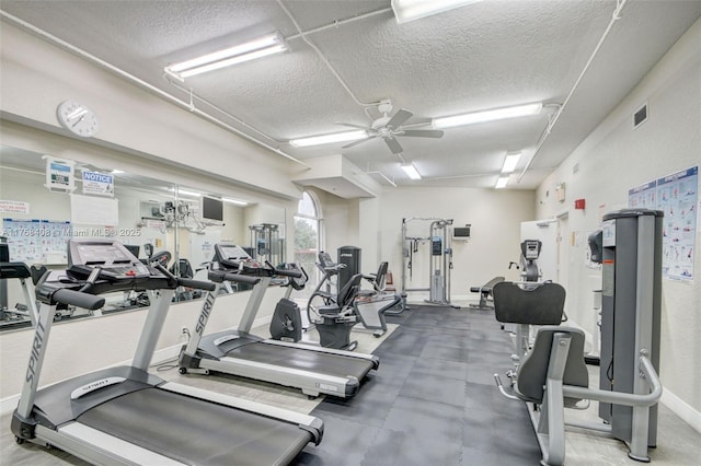 exercise room featuring visible vents, baseboards, a textured ceiling, and ceiling fan