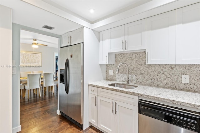 kitchen with wood finished floors, a sink, visible vents, white cabinets, and appliances with stainless steel finishes