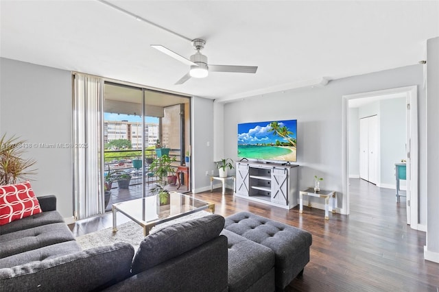 living room with floor to ceiling windows, ceiling fan, baseboards, and wood finished floors