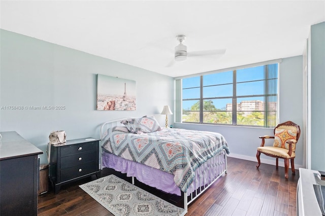 bedroom with dark wood-style floors, baseboards, and a ceiling fan