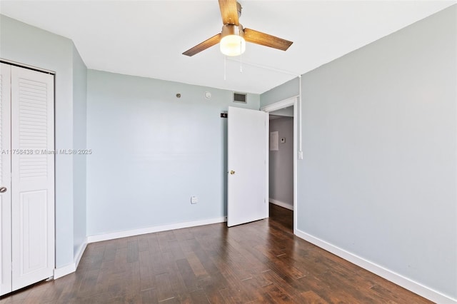 unfurnished bedroom with visible vents, a closet, baseboards, and wood finished floors