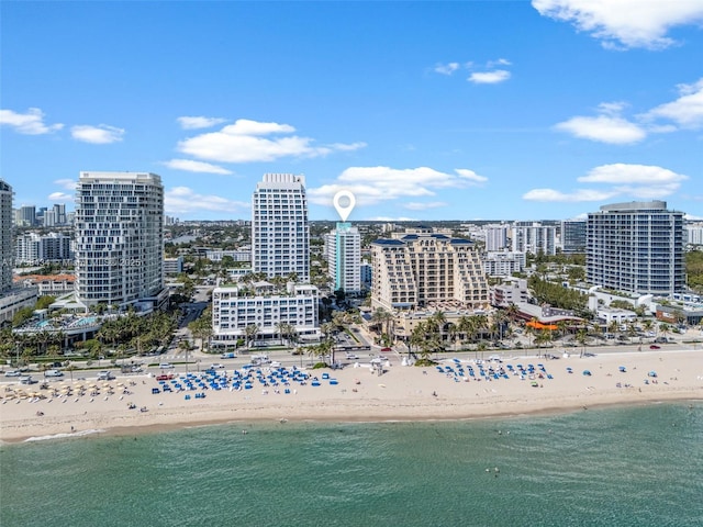 birds eye view of property featuring a water view, a view of city, and a view of the beach