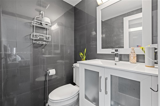 full bathroom featuring a shower stall, tile walls, toilet, and vanity