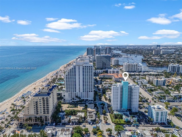 bird's eye view featuring a water view, a beach view, and a city view