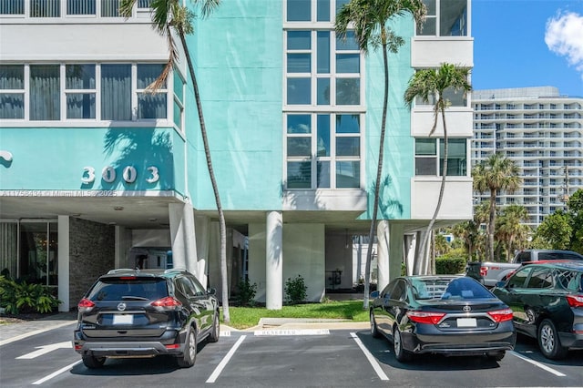 view of building exterior with uncovered parking