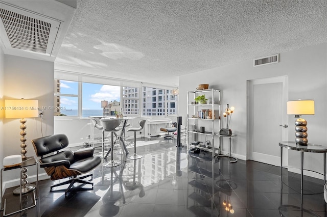 interior space featuring baseboards, visible vents, and a textured ceiling