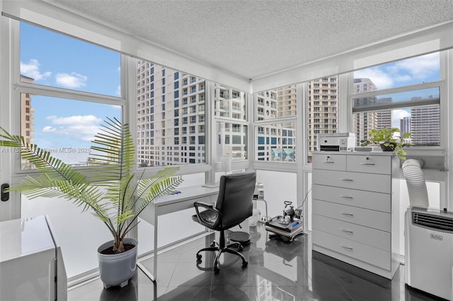 office space with heating unit, a city view, and a textured ceiling