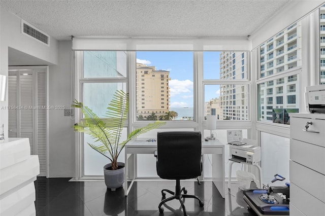 tiled home office with visible vents and a textured ceiling