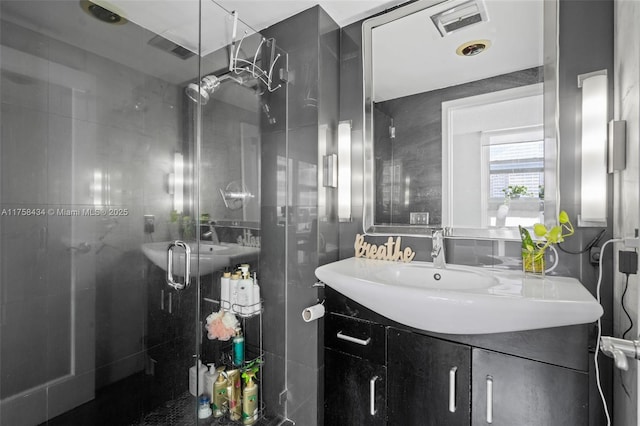 full bathroom with a shower stall and vanity