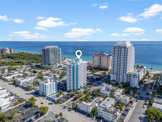 birds eye view of property with a water view and a city view