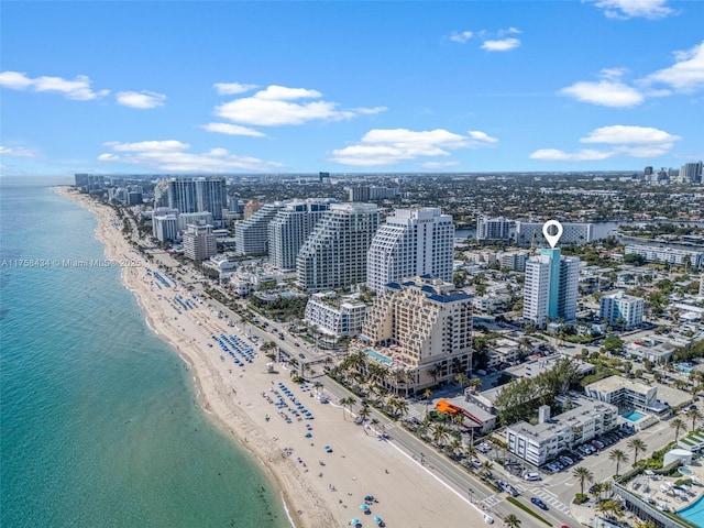 birds eye view of property featuring a city view, a water view, and a beach view