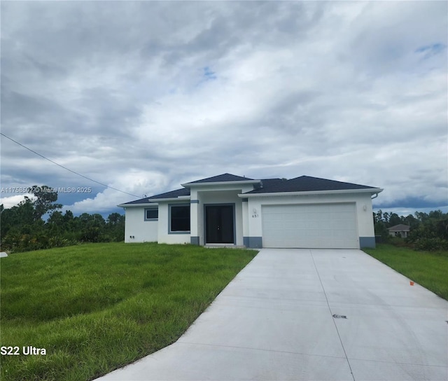 view of front of house featuring driveway, a front lawn, an attached garage, and stucco siding