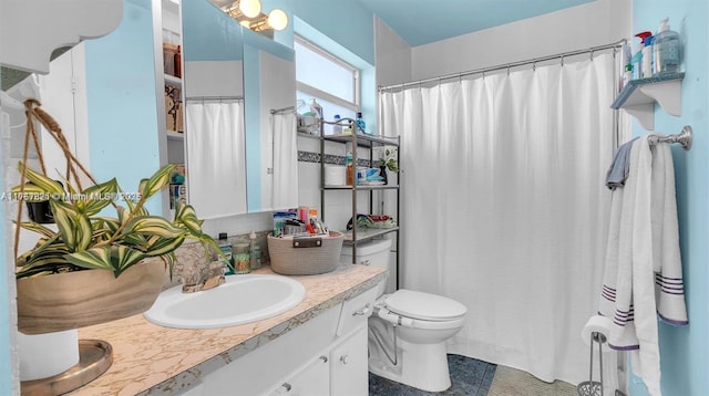 full bathroom with curtained shower, vanity, toilet, and tile patterned floors