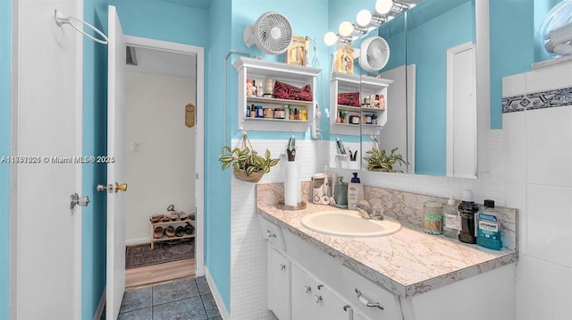 bathroom with tile walls, vanity, and tile patterned floors