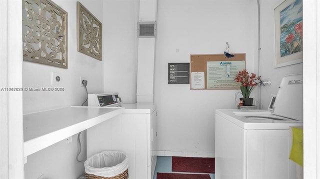 laundry area with visible vents and washer and dryer