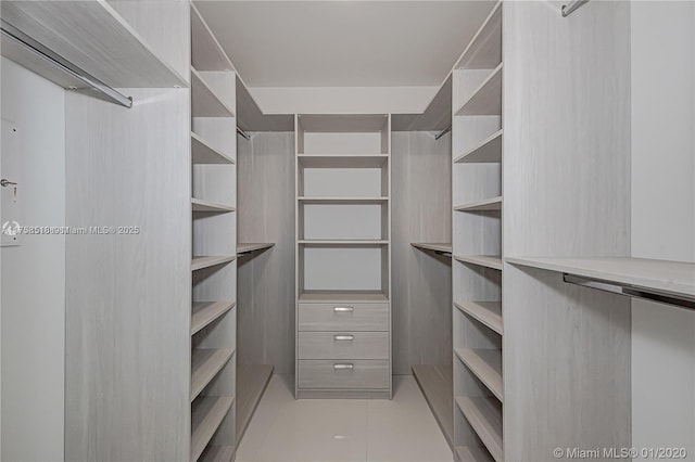 spacious closet with tile patterned floors