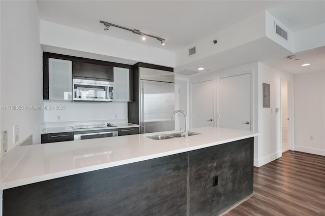 kitchen with dark wood-style flooring, light countertops, visible vents, appliances with stainless steel finishes, and a sink