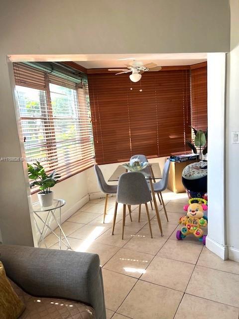 dining room with light tile patterned floors and baseboards