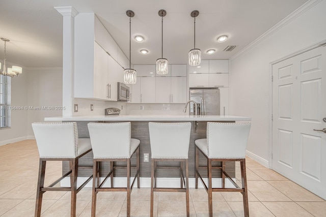 kitchen featuring visible vents, ornamental molding, appliances with stainless steel finishes, light countertops, and light tile patterned flooring