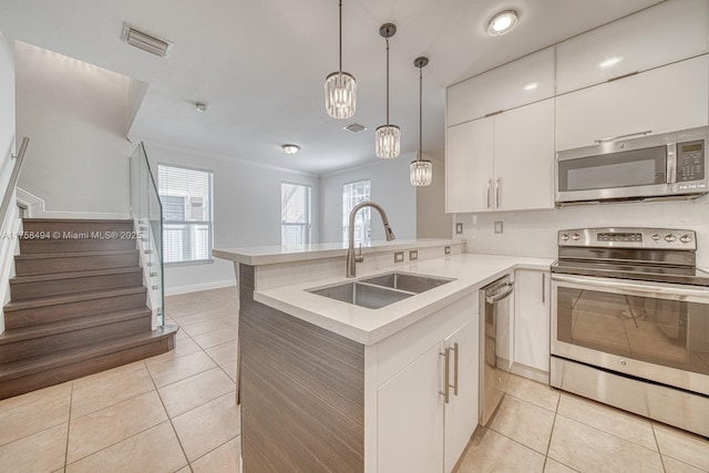 kitchen with light tile patterned floors, light countertops, visible vents, appliances with stainless steel finishes, and a sink