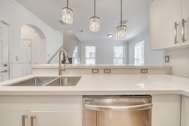 kitchen featuring ornamental molding, stainless steel dishwasher, a sink, and visible vents