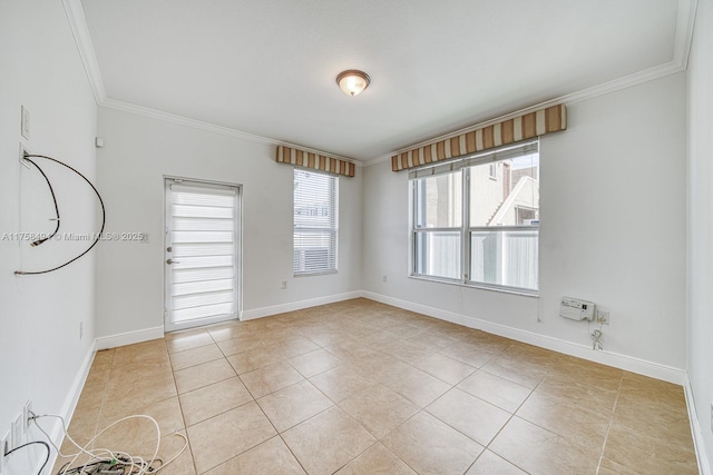 spare room featuring baseboards, ornamental molding, and light tile patterned flooring