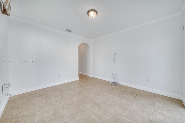 unfurnished room featuring arched walkways, visible vents, crown molding, and baseboards