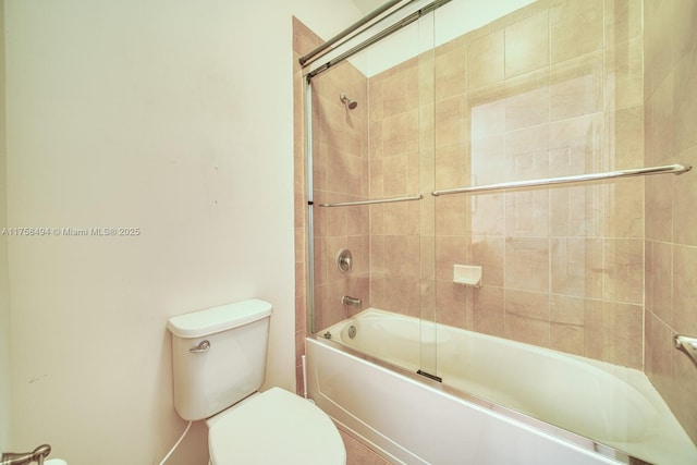 bathroom featuring toilet and enclosed tub / shower combo