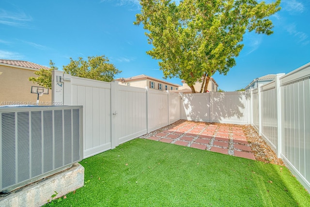 view of yard with central air condition unit, a patio area, and a fenced backyard