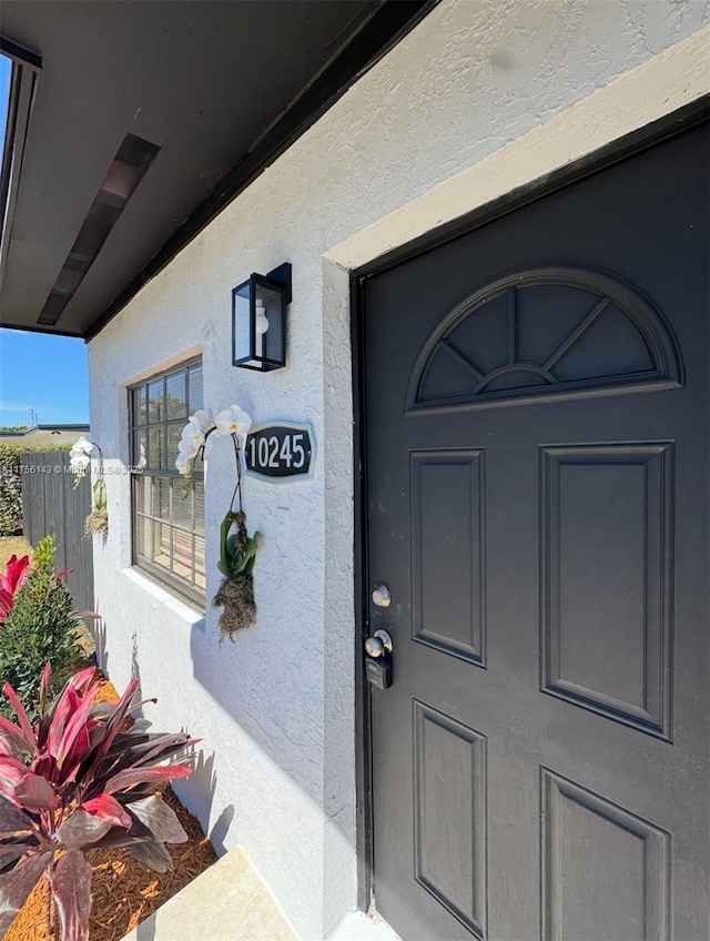 property entrance featuring stucco siding