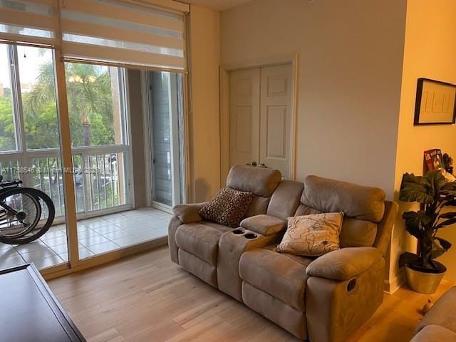 living room featuring light wood finished floors and floor to ceiling windows