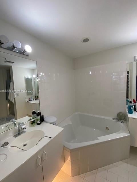 full bathroom with a garden tub, vanity, and tile patterned floors