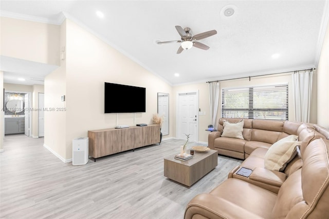 living area featuring high vaulted ceiling, a ceiling fan, baseboards, light wood-style floors, and crown molding