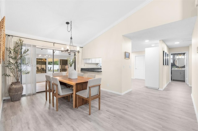 dining space featuring lofted ceiling, a chandelier, light wood-style flooring, baseboards, and crown molding