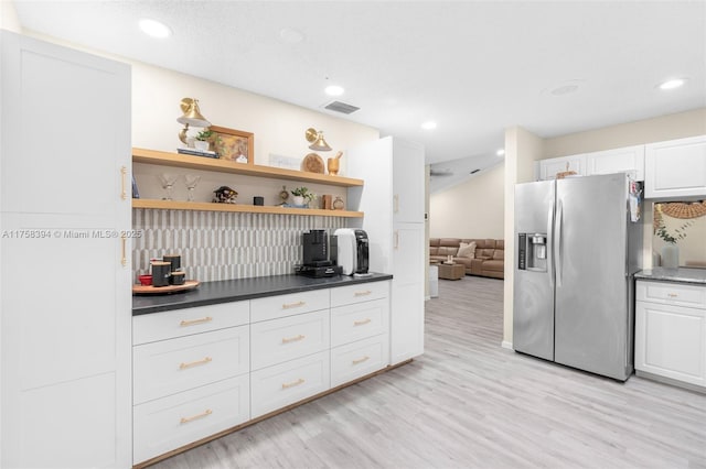 kitchen featuring visible vents, light wood-style floors, white cabinetry, stainless steel refrigerator with ice dispenser, and open shelves