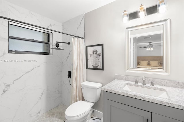 bathroom with toilet, vanity, and a marble finish shower