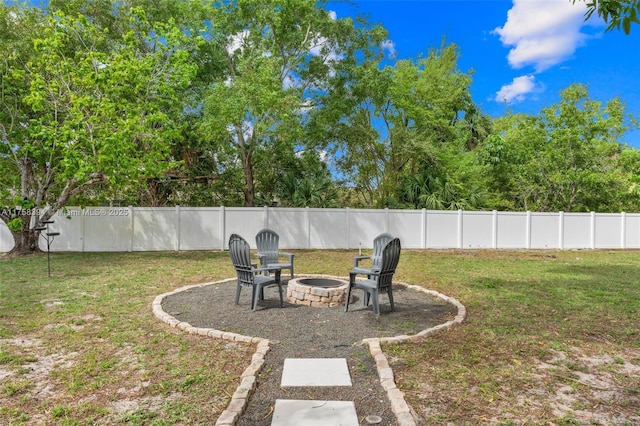 view of yard with an outdoor fire pit and a fenced backyard