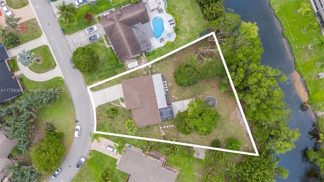 birds eye view of property with a water view