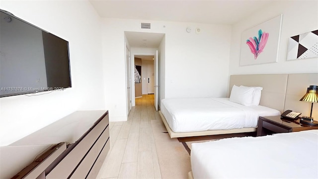 bedroom with visible vents and light wood-style flooring