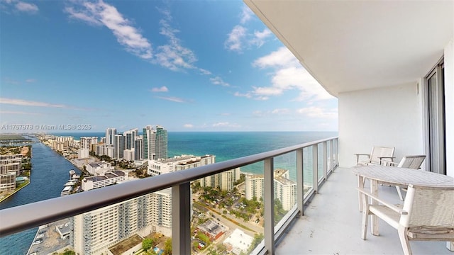 balcony with a water view and a city view