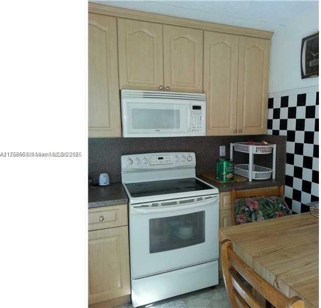 kitchen with white appliances and light brown cabinets