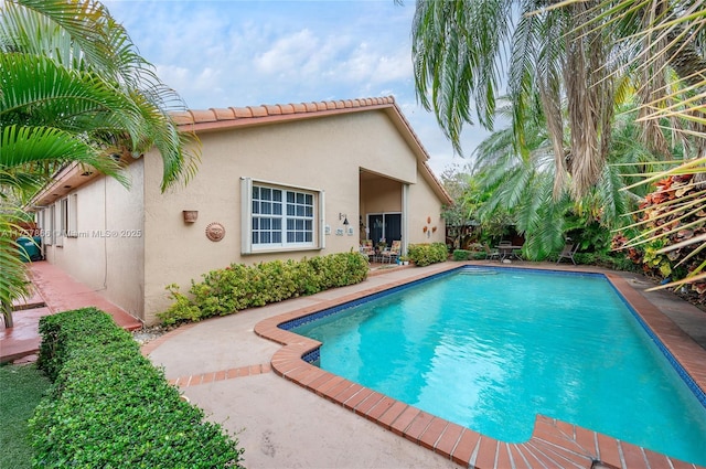 pool featuring a patio area and fence