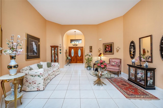 tiled foyer with arched walkways and baseboards